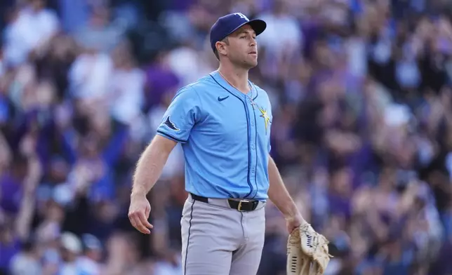 Tampa Bay Rays pitcher Jason Adam reacts after giving up a game-winning grand slam to Colorado Rockies' Ryan McMahon in a baseball game Friday, April 5, 2024, in Denver. (AP Photo/David Zalubowski)