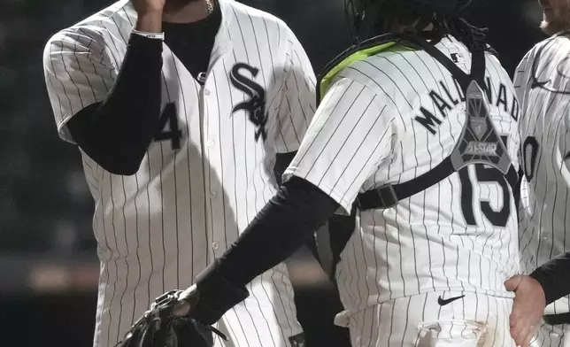 Chicago White Sox's Eloy Jiménez, left, and catcher Martín Maldonado (15) celebrate after a win over the Tampa Bay Rays in a baseball game Friday, April 26, 2024, in Chicago. (AP Photo/Charles Rex Arbogast)