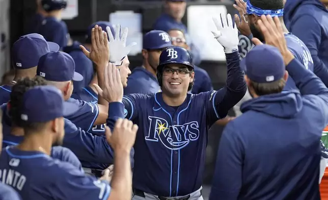Tampa Bay Rays' Austin Shenton celebrates in the dugout after his home run off Chicago White Sox pitcher Jonathan Cannon during the fifth inning of a baseball game Saturday, April 27, 2024, in Chicago. (AP Photo/Charles Rex Arbogast)