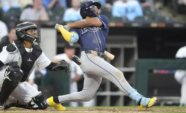 Tampa Bay Rays' Richie Palacios, right, and Chicago White Sox catcher Martín Maldonado, left, watch Palacios' two-run home run during the fourth inning of a baseball game Saturday, April 27, 2024, in Chicago. (AP Photo/Charles Rex Arbogast)