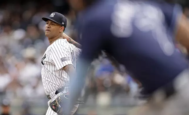 New York Yankees pitcher Luis Gil is called for a balk against Tampa Bay Rays' José Caballero during the third inning of a baseball game Sunday, April 21, 2024, in New York. (AP Photo/Adam Hunger)