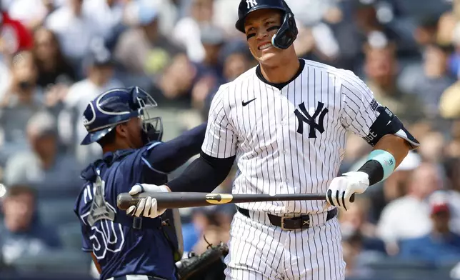 New York Yankees' Aaron Judge (99) reacts after striking out against the Tampa Bay Rays during the sixth inning inning of a baseball game, Saturday, April 20, 2024 in New York. (AP Photo/Noah K. Murray)