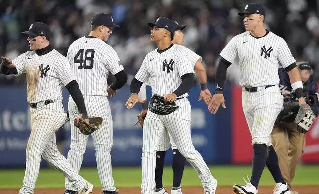 New York Yankees' Aaron Judge, front right, Juan Soto, second from front right, Anthony Rizzo, second from left, and Alex Verdugo, left, celebrate after a baseball game against the Tampa Bay Rays, Friday, April 19, 2024, in New York. (AP Photo/Frank Franklin II)
