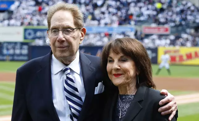 New York Yankees broadcasters John Sterling and Suzyn Waldman pose during a retirement ceremony for Sterling before a baseball game against the Tampa Bay Rays at Yankee Stadium in New York, Saturday, April 20, 2024. (AP Photo/Noah K. Murray)