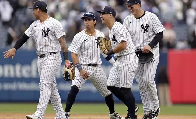 From left to right, New York Yankees' Gleyber Torres, Oswaldo Cabrera, Anthony Volpe and Anthony Rizzo celebrate after defeating the Tampa Bay Rays in a baseball game Sunday, April 21, 2024, in New York. (AP Photo/Adam Hunger)
