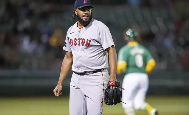 Boston Red Sox relief pitcher Kenley Jansen walks off the field after getting a strikeout to end the ninth inning of a baseball game against the Oakland Athletics, Tuesday, April 2, 2024, in Oakland, Calif. (AP Photo/Nic Coury)