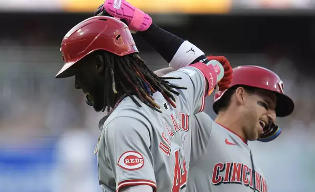 Cincinnati Reds' Elly De La Cruz, left, celebrates with teammate Spencer Steer after hitting a home run during the first inning of a baseball game against the San Diego Padres, Monday, April 29, 2024, in San Diego. (AP Photo/Gregory Bull)