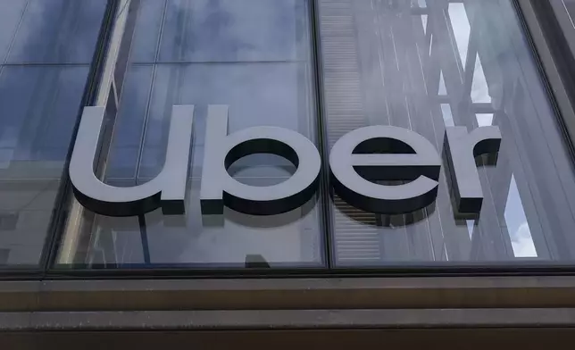 FILE - An Uber sign is displayed at the company's headquarters in San Francisco, Monday, Sept. 12, 2022. The future of Uber and Lyft in Minneapolis has been a source of concern and debate in recent weeks after the City Council voted last month to require that ride-hailing companies pay drivers a higher rate while they are within city limits. (AP Photo/Jeff Chiu, File)