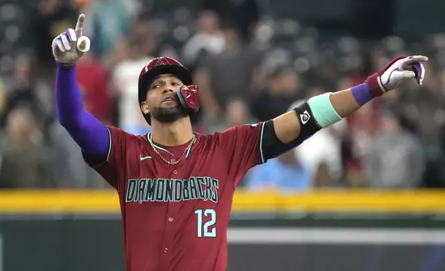 Arizona Diamondbacks' Lourdes Gurriel Jr. reacts after hitting an RBI double against the Colorado Rockies during the fifth inning of a baseball game Sunday, March 31, 2024, in Phoenix. (AP Photo/Rick Scuteri)