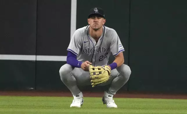 Colorado Rockies right fielder Nolan Jones reacts after dropping a fly ball hit by Arizona Diamondbacks' Ketel Marte during the fifth inning of a baseball game Sunday, March 31, 2024, in Phoenix. (AP Photo/Rick Scuteri)