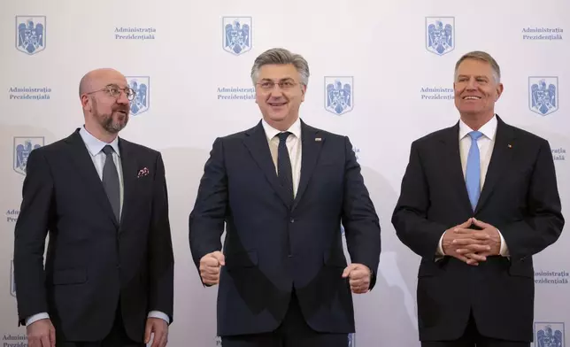 European Council President Charles Michel, left, poses with Croatia's Prime Minister Andrej Plenkovic, center, and Romanian President Klaus Iohannis at the Cotroceni Presidential Palace in Bucharest, Romania, Wednesday, April 3, 2024. (AP Photo/Andreea Alexandru)