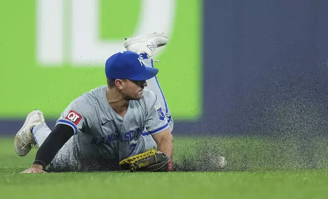 Kansas City Royals outfielder Adam Frazier misses a diving catch on a hit by Toronto Blue Jays' George Springer during eighth-inning baseball game action in Toronto, Monday, April 29, 2024. (Nathan Denette/The Canadian Press via AP)