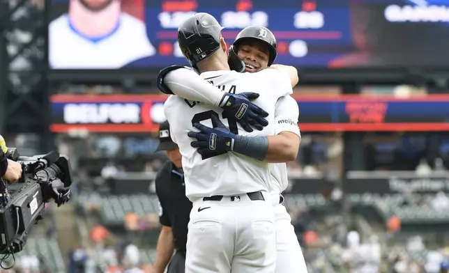 Detroit Tigers' Wenceel Pérez, right, is hugged by Mark Canha, left, after hitting a two-run home run against the Kansas City Royals in the first inning of a baseball game, Sunday, April 28, 2024, in Detroit. (AP Photo/Jose Juarez)
