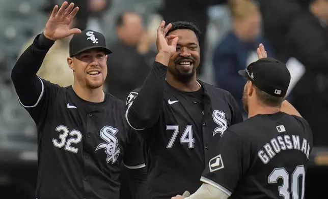 Chicago White Sox's Gavin Sheets, Eloy Jiménez and Robbie Grossman, from left, celebrate the team's win over the Kansas City Royals in the second baseball game of a doubleheader Wednesday, April 17, 2024, in Chicago. (AP Photo/Erin Hooley)