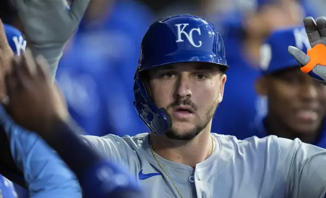 Kansas City Royals' Vinnie Pasquantino celebrates in the dugout after hitting a home run during the fourth inning of a baseball game against the Chicago White Sox, Monday, April 15, 2024, in Chicago. (AP Photo/Erin Hooley)