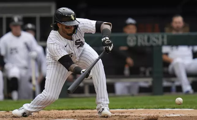 Chicago White Sox's Martín Maldonado hits a sacrifice bunt during the fifth inning of the first baseball game of a doubleheader against the Kansas City Royals Wednesday, April 17, 2024, in Chicago. (AP Photo/Erin Hooley)