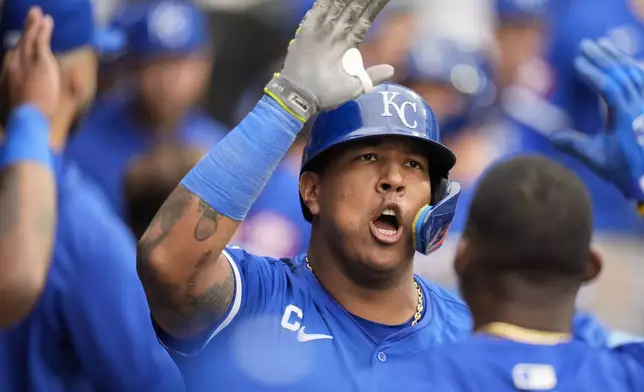 Kansas City Royals' Salvador Perez celebrates in the dugout after hitting a home run during the eighth inning in the first baseball game of a doubleheader against the Chicago White Sox, Wednesday, April 17, 2024, in Chicago. (AP Photo/Erin Hooley)