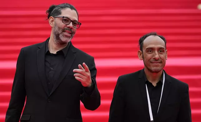 Mexican director Miguel Salgado, right, and Alfredo Mendoza, actor and screenwriter, pose for a photo as they arrive at the closing ceremony of the 46th Moscow International Film Festival in Moscow, Russia, on Friday, April 26, 2024. A Mexican film has won the top prize at the Moscow International Film Festival which took place as major Western studios boycott the Russian market and as Russia's war in Ukraine grinds into its third year. "Shame," a film by director Miguel Salgado and co-produced by Mexico and Qatar, was the most highly awarded film at the festival which began in 1935 and which has been held annually since 1999. (AP Photo/Alexander Zemlianichenko)