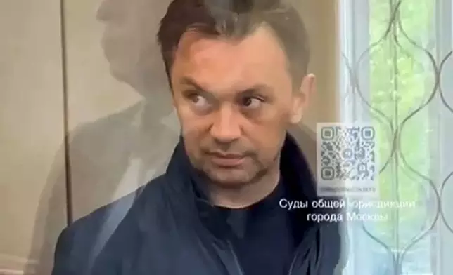 This photo taken from video released by Basmanny District Court press service on Thursday, April 25, 2024, shows businessman Alexander Fomin standing in a glass cage in the Basmanny District Court in Moscow, Russia. Moscow's court service says a third man has been detained in a major bribery case involving a Russian deputy defense minister. It says businessman Alexander Fomin is suspected of paying bribes to Deputy Defense Minister Timur Ivanov as well as Ivanov's associate, (Basmanny District Court press service via AP)