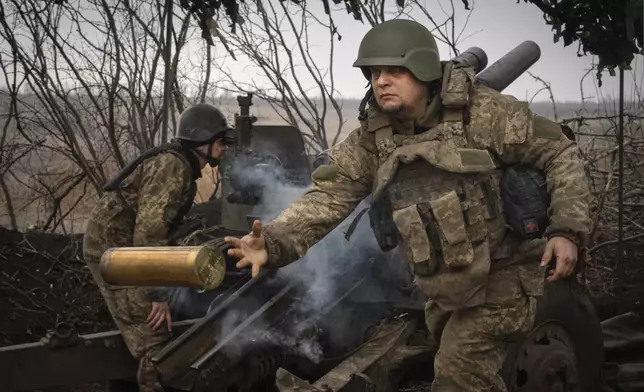 FILE - Ukrainian soldiers with the 71st Jaeger Brigade fire a M101 howitzer at Russian positions on the front line, near the city of Avdiivka in Ukraine’s Donetsk region, on March 22, 2024. (AP Photo/Efrem Lukatsky, File)