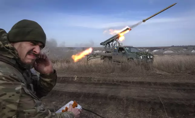 FILE - A Ukrainian officer with the 56th Separate Motorized Infantry Mariupol Brigade fires rockets from a pickup truck at Russian positions on the front line near Bakhmut in Ukraine’s Donetsk region on March 5, 2024. The outgunned and outnumbered Ukrainian troops are struggling to halt Russian advances as a new U.S. aid package is stuck in Congress. (AP Photo/Efrem Lukatsky, File)