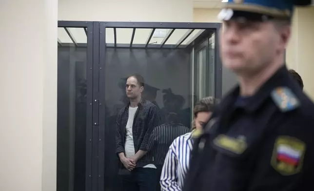 Wall Street Journal reporter Evan Gershkovich stands in a glass cage in a courtroom at the First Appeals Court of General Jurisdiction in Moscow, Russia, Tuesday, April 23, 2024. A court will considers an appeal against the arrest of WSJ reporter Evan Gershkovich who was detained on espionage charges in Yekaterinburg last year. (AP Photo/Alexander Zemlianichenko)