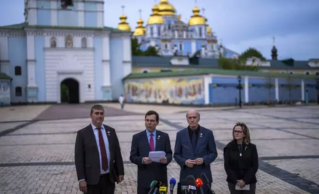 From left, U.S. representatives Nathaniel Moran, R-Tx, Tom Kean Jr, R-NJ, Bill Keating, D-Mass, and Madeleine Deane, D-Pa, talk to journalists during a joint news conference outside Saint Michael cathedral in Kyiv, Ukraine, Monday, April 22, 2024. A bipartisan delegation of U.S. Congress members met President Volodymyr Zelenskyy in Kyiv on Monday and praised the historic House vote to approve $61 billion in military aid for Ukraine. (AP Photo/Francisco Seco)