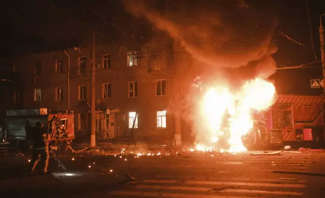 Firefighter's vehicle is seen on fire after Russian drone strikes on residential neighborhood in Kharkiv, Ukraine, on Thursday, April. 4, 2024. (AP Photo/George Ivanchenko)