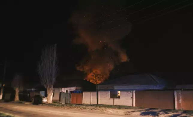 Smoke rises above houses after a Russian drone strike on residential neighborhood in Kharkiv, Ukraine, on Thursday, April. 4, 2024. (AP Photo/George Ivanchenko)