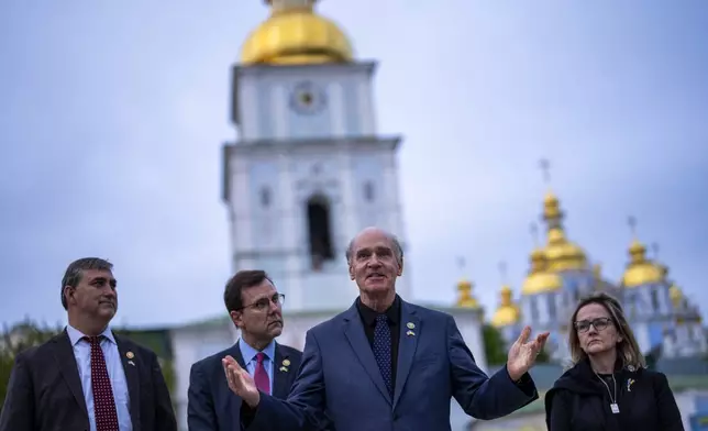 From left, U.S. representatives Nathaniel Moran, R-Tx, Tom Kean Jr, R-NJ, Bill Keating, D-Mass, and Madeleine Deane, D-Pa, speak to journalists during a joint news conference outside Saint Michael cathedral in Kyiv, Ukraine, Monday, April 22, 2024. A bipartisan delegation of U.S. Congress members met President Volodymyr Zelenskyy in Kyiv on Monday and praised the historic House vote to approve $61 billion in military aid for Ukraine. (AP Photo/Francisco Seco)