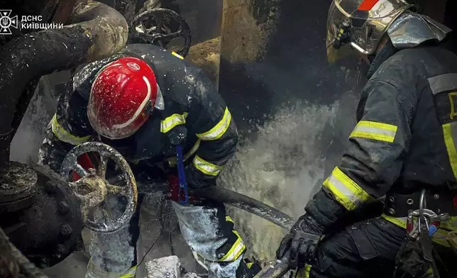 In this photo provided by the Ukrainian Emergency Service, emergency workers extinguish a fire after a Russian attack on the Trypilska thermal power plant in Ukrainka, Kyiv region, Ukraine, Thursday, April 11, 2024. (Ukrainian Emergency Service via AP)
