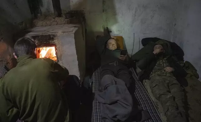 FILE - Soldiers of Ukraine's 17th Tank Brigade rest in a shelter, in Chasiv Yar, the site of fierce battles with the Russian troops in the Donetsk region, Ukraine, Thursday, Feb. 29, 2024. (AP Photo/Efrem Lukatsky, File)