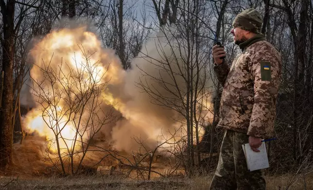 FILE - A Ukrainian officer observes the firing of a 152-mm Self-Propelled Howitzer 2S3, towards Russian positions at the frontline, near Bakhmut, Donetsk region, Ukraine, Monday, March 25, 2024. (AP Photo/Efrem Lukatsky, File)