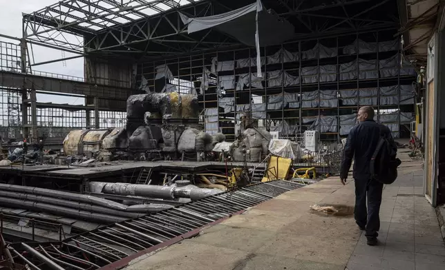 A worker walks inside a power plant that was destroyed by a Russian rocket attack on March 22, in Kharkiv, Ukraine, on Wednesday, April 17, 2024. (AP Photo/Evgeniy Maloletka)