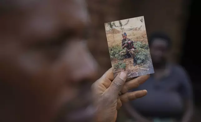 Patrick Hakizimana, a Hutu peasant who was jailed from 1996 to 2007 for his alleged role in the genocide as an army corporal, shows a photo during his time as a soldier in Gahanga the outskirts of Kigali, Rwanda, Tuesday, April 4, 2024. The country will commemorate on April 7, 2024 the 30th anniversary of the genocide when ethnic Hutu extremists killed neighbours, friends and family during a three-month rampage of violence aimed at ethnic Tutsis and some moderate Hutus, leaving a death toll that Rwanda puts at 1,000,050. (AP Photo/Brian Inganga)