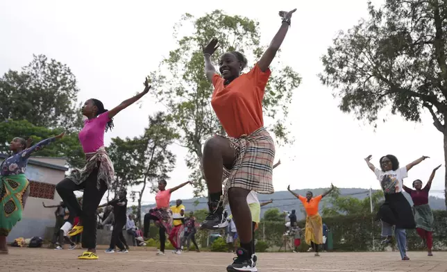 Female traditional dancers perform amaraba Traditional dance at club "rafiki" (Swahili word for 'Friend'), Centre in Kigali, Rwanda, Wednesday, Apr. 3, 2024. Rwanda will commemorates for the 30th time the 1994 genocide on April 7, in which 800,000 mostly Tutsis, but also moderate Hutus, were slaughtered. (AP Photo/Brian Inganga)