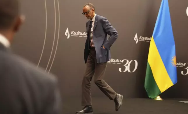 Rwanda's President Paul Kagame leaves after a press conference at Kigali Convention Centre in Kigali, Rwanda, Monday, April 8, 2024. Rwandans are commemorating 30 years since the genocide in which an estimated 800,000 people were killed by government-backed extremists, shattering this small east African country that continues to grapple with the horrific legacy of the massacres. (AP Photo/Brian Inganga)
