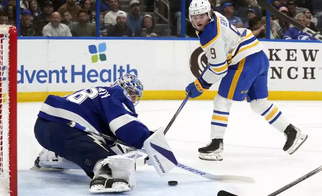 Tampa Bay Lightning goaltender Andrei Vasilevskiy (88) stops a shot by Buffalo Sabres left wing Zach Benson (9) during the first period of an NHL hockey game Monday, April 15, 2024, in Tampa, Fla. (AP Photo/Chris O'Meara)