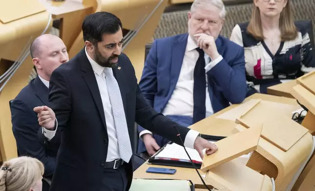 FILE - Scotland's First Minister Humza Yousaf speaks during First Minster's Questions (FMQ's) at the Scottish Parliament in Holyrood, Edinburgh, April 25, 2024. Scotland’s first minister, Humza Yousaf, has resigned on Monday, April 29, 2024, rather than face a no-confidence vote just days after he torpedoed a coalition with the Green Party by ditching a target for fighting climate change. (Lesley Martin/PA via AP, File)