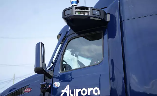 A self-driving tractor trailer is displayed at a test track in Pittsburgh, Thursday, March 14, 2024. The truck, outfitted with 25 laser, radar and camera sensors, is owned by Pittsburgh-based Aurora Innovation Inc. Late this year, Aurora plans to start hauling freight on Interstate 45 between the Dallas and Houston areas with 20 driverless trucks. (AP Photo/Gene J. Puskar)