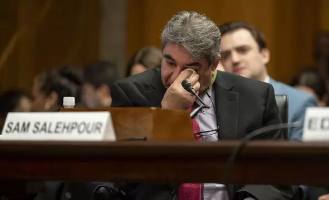 Boeing Quality Engineer Sam Salehpour wipes his eyes during a Senate Homeland Security and Governmental Affairs - Subcommittee on Investigations hearing to examine Boeing's broken safety culture on Wednesday, April 17, 2024, in Washington. (AP Photo/Kevin Wolf)