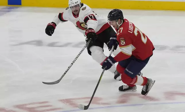 Florida Panthers center Eetu Luostarinen (27) and Ottawa Senators right wing Zack MacEwen (17) go after the puck during the first period of an NHL hockey game, Tuesday, April 9, 2024, in Sunrise, Fla. (AP Photo/Marta Lavandier)