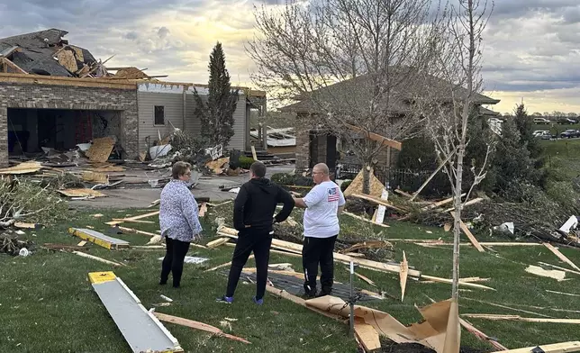 Homeowners assess damage after a tornado caused extensive damage in their neighborhood northwest of Omaha in Bennington, Neb., Friday, April 26, 2024. (AP Photo/Josh Funk)