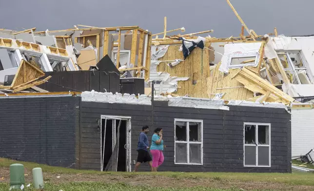 Damage is seen to houses after a tornado passed through the area near Omaha, Neb., on Friday, April 26, 2024. (Chris Machian/Omaha World-Herald via AP)