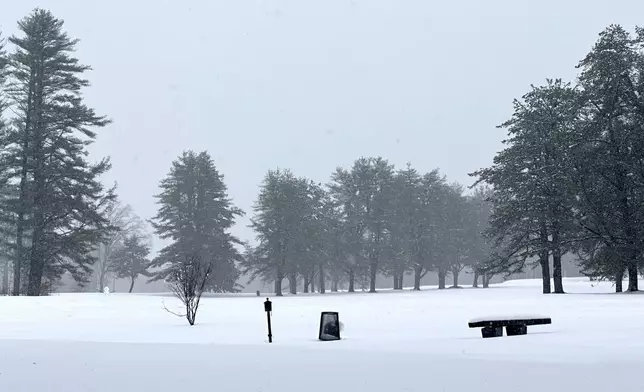 A snowman stands on Beaver Meadow Golf Course in Concord, N.H., Thursday, April 4, 2024. An early spring nor'easter hammered the Northeast with heavy snow, rain and high winds, with some northern areas expected to get up to two feet of snow. (AP Photo/Kathy McCormack)