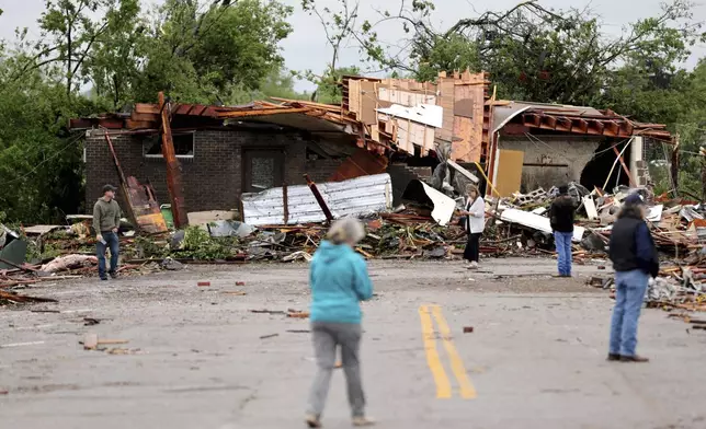 People look at tornado damage in Sulphur, Okla., Sunday, April 28, 2024, after severe storms hit the area the night before. (Bryan Terry/The Oklahoman via AP)