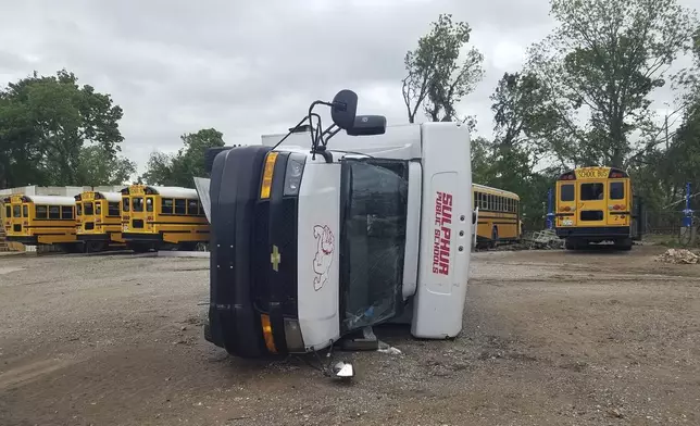 A school bus lies on its side after being knocked over during a tornado in Sulphur, Okla., Sunday, April 28, 2024. (AP Photo/Ken Miller)