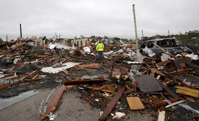A man is surrounded by tornado damage after severe storms moved through the night before in Sulphur, Okla., Sunday, April 28, 2024. (Bryan Terry/The Oklahoman via AP)