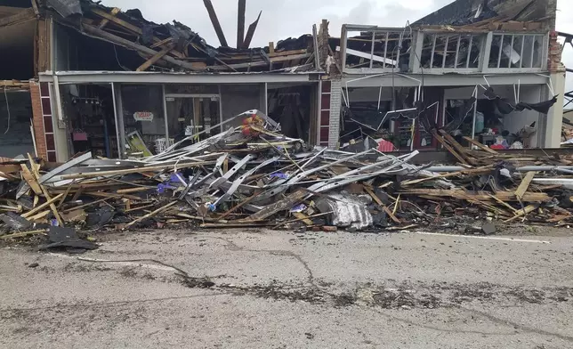 A row of buildings is left damaged by a tornado in Sulphur, Okla., Sunday, April 28, 2024. (AP Photo/Ken Miller)