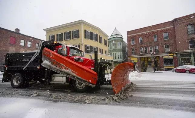 A snowblower truck from Rockingham Highway Department clears the snow from downtown Bellows Falls, Vt., on Thursday, April 4, 2024. (Kristopher Radder/The Brattleboro Reformer via AP)